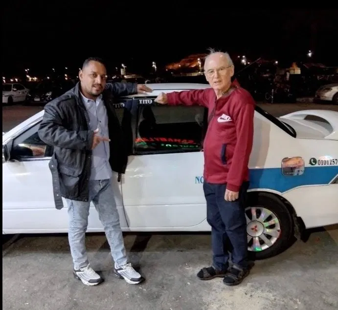 Tito greeting a traveller during a night airport transfer